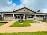 Shows several of the front entrances to a two story brick row house style building